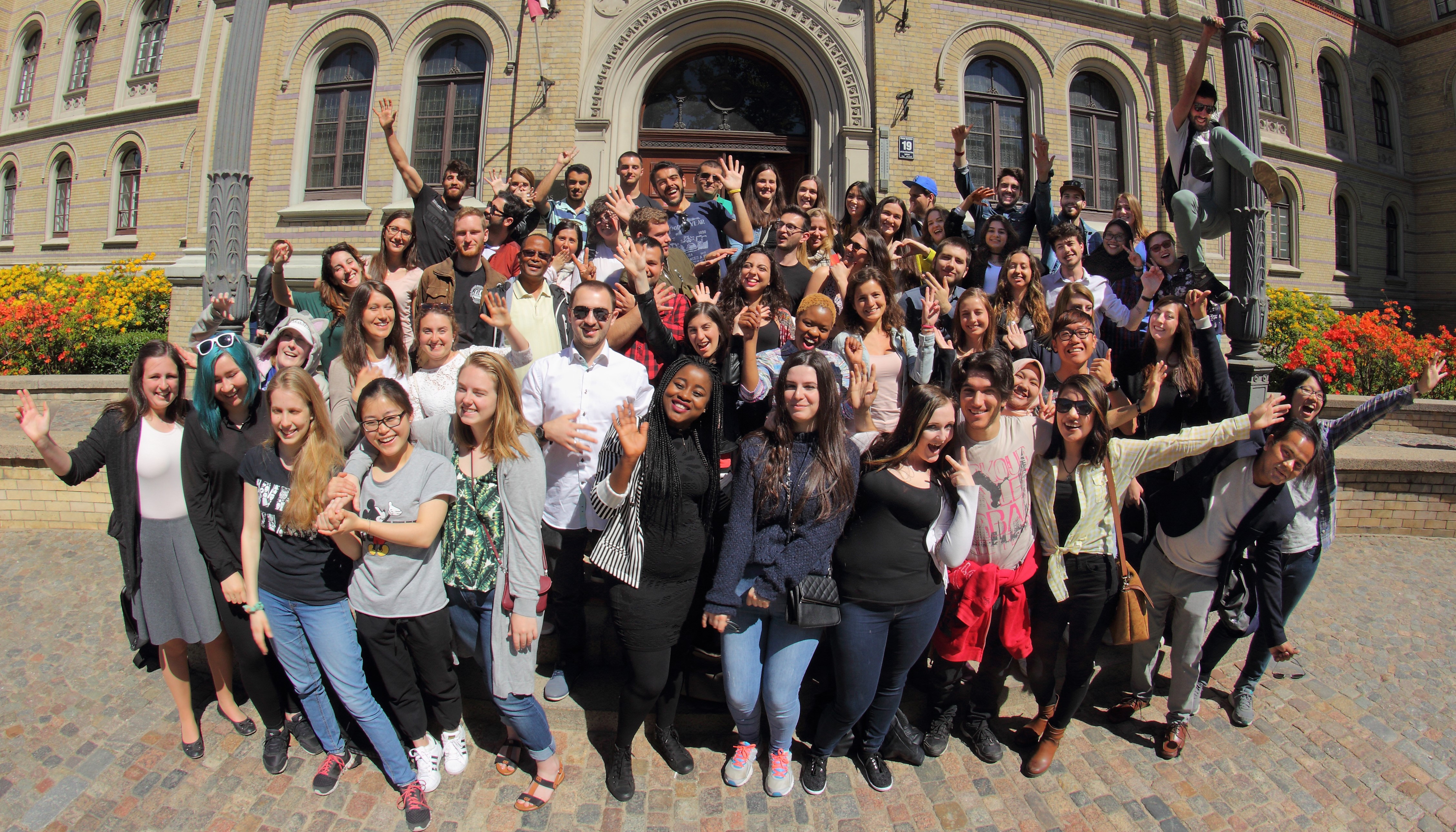 Group photo of students in front of the University of Latvia main building
