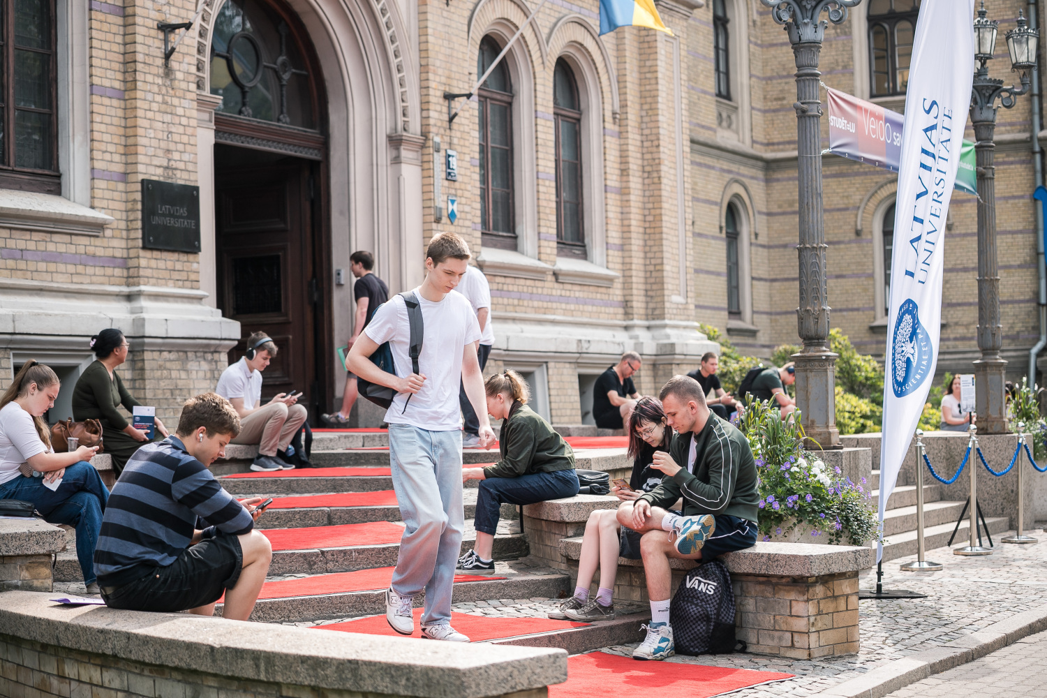 Uzņemšanas laiks LU – topošie studenti uz LU galvenās ieejas kāpnēm Raiņa 19, Rīgā